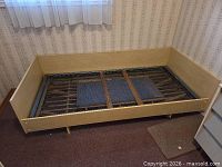 Overall view of pressed wood twin day bed frame without mattress