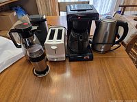 All five appliances lined up on table