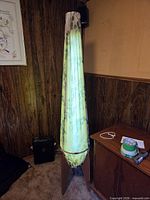 Full view of lamp illuminated showing wood base and floral fabric shade