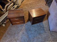 Pair of matching teak two-drawer end tables front view