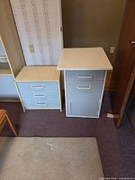Light woodgrain three-drawer cabinet and grey pedestal side by side