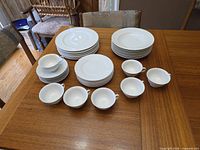 Full set laid out showing stacks of dinner and salad plates, teacups, and one bowl