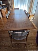 Table fully extended with six chairs around