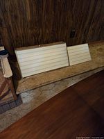 Two illuminated slide sorter light boxes resting against wall, showing size difference and overall appearance