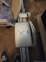 Motor housing atop rail with control label visible