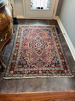 Full view of the Persian rug on floor showing design and size