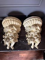 Front view of both cherub wall planters