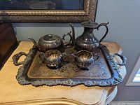 Full view of all five silver plated pieces on tray