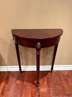 Front view of demi-lune console table showing full form and finish