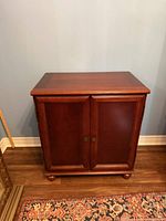 Front view of dark wood Bombay cabinet with two doors