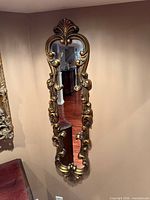 Full view of the ornate vertical mirror on wall