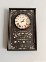 Full view of rectangular wall clock on wall showing entire design and clock face