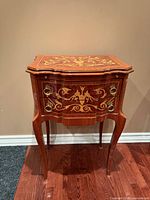 Front and side view showing marquetry, brass pulls, cabriole legs