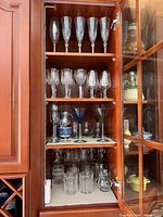 Cabinet view showing champagne flutes, wine goblets, martini glasses, tumblers