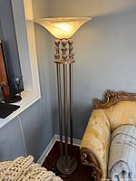 Full view of floor lamp beside sofa illustrating overall design and height