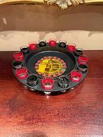Top view showing entire roulette drinking game set with shot glasses