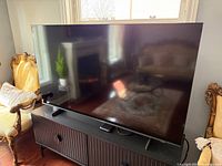 Front view of Samsung 65-inch TV on stand