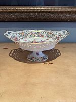 Full view of Schumann Bavaria reticulated pedestal bowl on pedestal showing floral decoration and lattice rim
