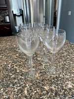 All eight wine glasses grouped on countertop