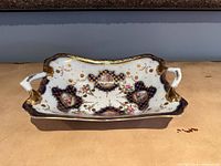 Front view of ornate handled porcelain dish