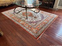 Full view of rug showing central medallion and red border