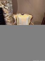 front view of accent chair showing wood frame, upholstery, pillow