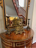 Full set on wooden console showing clock center and two candlesticks