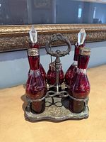 Full view of cruet set showing four bottles and stand