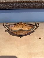 Front view showing bowl shape, handles, feet and interior design