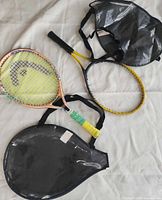 Both rackets and two cases laid out