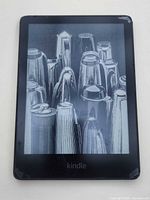 Front view of powered-on Kindle showing display and corner wear