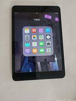 Front view of iPad mini displaying home screen
