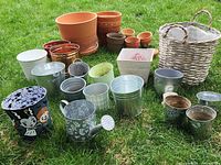 Full assortment of pots, pails, basket and watering can on grass