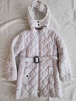 Full front view of quilted coat showing color, design, belt, hood, pockets, zipper