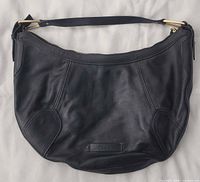 Front view of Cole Haan black leather shoulder bag