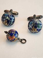 Full set: pair of globe cufflinks with matching pendant