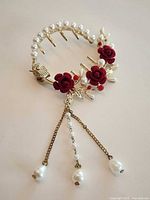 Full view of gold-tone hair comb showing roses, pearl row, and chain drops