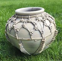 Front view of beige clay pot with rattan lattice