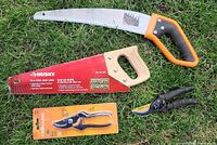 Overview of all four garden tools laid on grass