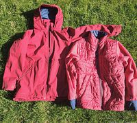 Vaude 2-in-1 jacket outer shell and inner quilted layer laid on grass