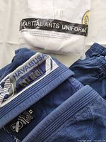 Blue Hayabusa gi and packaged white gi visible