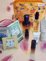 Group shot of cosmetic bag with assorted L'Occitane travel-size products