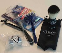 Lot overview: brush, pouch, hanger, seven razors (two blister-packed)