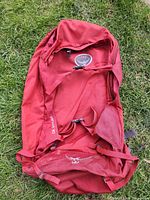 Front view of red Osprey Farpoint 70 main pack