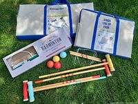 Overview of all four outdoor game sets with carrying cases, badminton box, croquet components