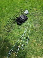 all items laid on grass: window box planters, liners, shepherd hooks, trellises, hardware bag