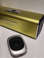 MusicMan speaker front with control buttons and AGPTEK clip MP3 player