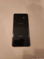 Rear view showing black glass back and camera module