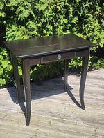 Full view of solid wood side table front and side showing drawer and curved legs