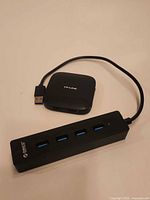TP-Link square hub and Orico rectangular hub side by side with cables visible